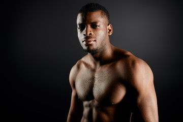 brutal handsome afro sportsman having a rest during workout in the sport center, healthy lifestyle, diet, beauty copy space