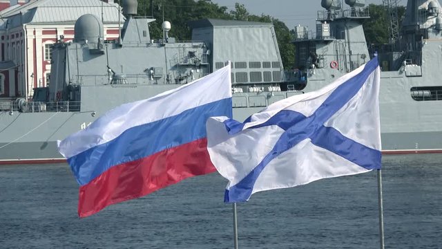 The Russian and Andreevsky flags flying. Navy day in Saint Petersburg
