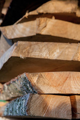 Fototapeta na wymiar Folded wooden planks in a sawmill. Piled boards as texture