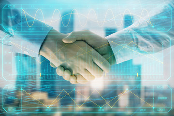 Fototapeta na wymiar Double exposure of financial graph on cityscape background with two businessman handshake. Concept of stock market deal