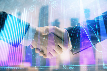 Obraz na płótnie Canvas Double exposure of financial graph on cityscape background with two businessman handshake. Concept of stock market deal