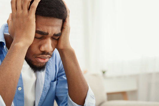 Lonely Depressed Man Near Window At Home