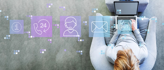 Customer service 24 hours 7 days a week with man using a laptop in a modern gray chair