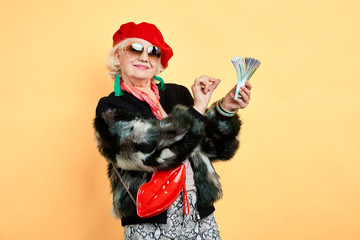 Happy aged woman holding money, counting it, Emotion and feelings concept.old businesswoman holding...