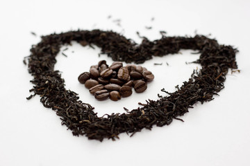 Background from black tea and coffee. Tea leaves in the form of a heart