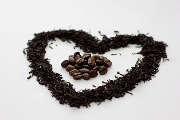 Background from black tea and coffee. Tea leaves in the form of a heart