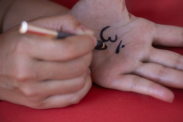 Female Hand painting Om symbol on the other hand  for yoga practice and meditation.