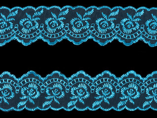 Blue laces on black background. Lacework concept