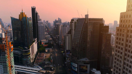 Fototapeta na wymiar Aerial city view of Bangkok downtown with crossroads and roads, Flying over Bangkok, Thailand.