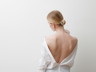 Minimalist photo, Fashionable girl in stylish summer things - white shirt. View from the back....