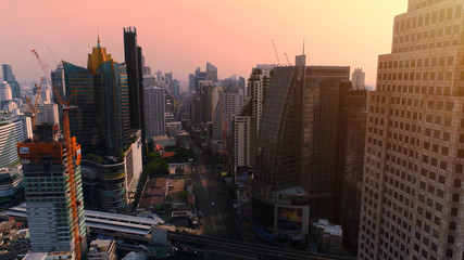 Aerial city view of Bangkok downtown with crossroads and roads, Flying over Bangkok, Thailand.
