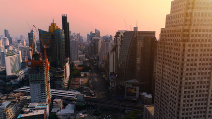 Aerial city view of Bangkok downtown with crossroads and roads, Flying over Bangkok, Thailand.