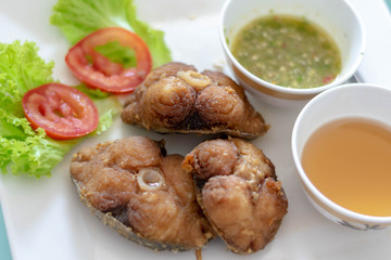 Close up of Deep fried King Mackerel fish with sauce Recipe (selective focus)