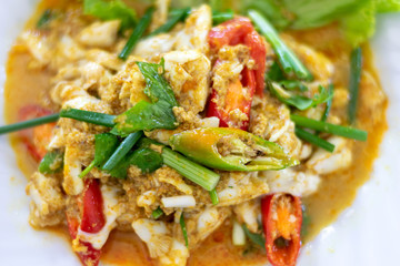 Close up of fried seafood with curry powder on white plate. (Selective focus)