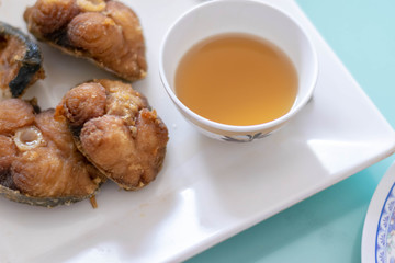 Close up of Deep fried King Mackerel fish with sauce Recipe (selective focus)