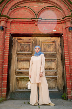 Young Muslim woman in blue hijab and beige casualwear