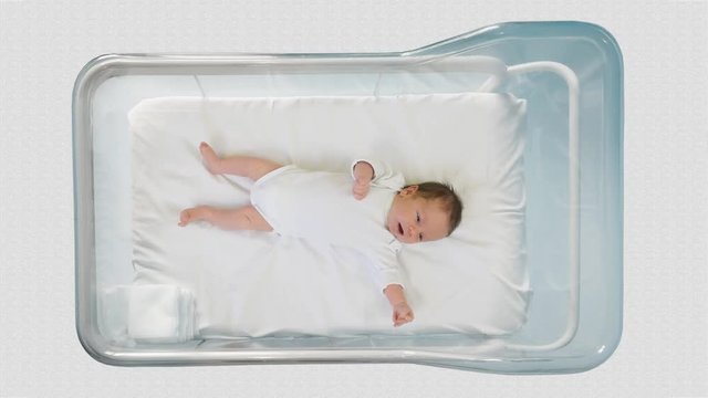 Little newborn moving in a hospital child bed