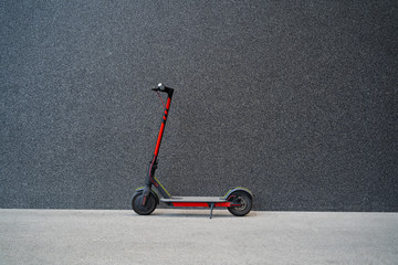 E scooter next to black modern wall, no people  © phoenix021