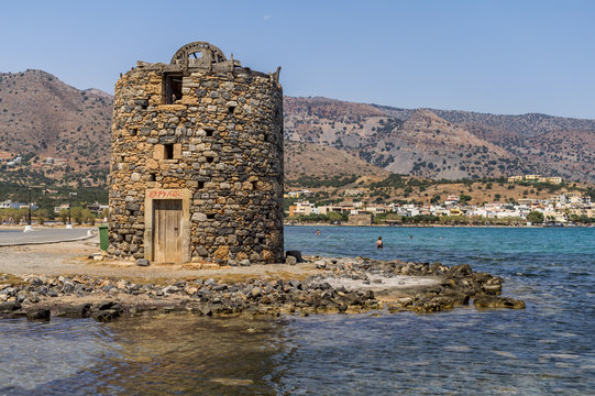 Ancient ruins of windmill and port in Elounda town, Crete island, Greece