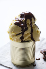 Homemade ice cream in an iron jar on a light background