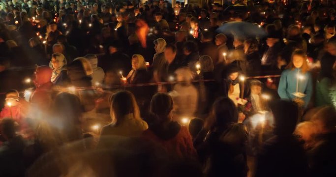 Easter revival ceremony, christian priest gives the lights to people in crowd, timelapse