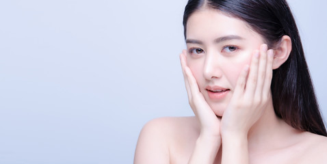 Fototapeta premium Beauty skin care asian woman smile to you isolated on blue background with shy emotional.