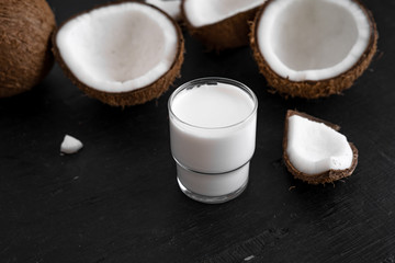 Fototapeta na wymiar Close-Up Of Coconut milk Against Black background