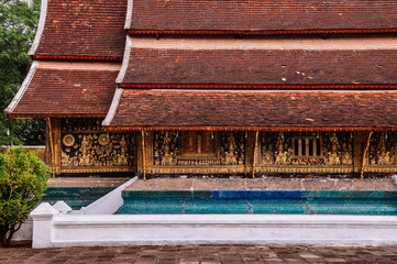 Golden Buddism Mural art and mosaic wall at Wat Xieng thong, Luang Prabang - Laos