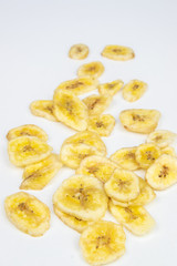 Dried banana pieces isolated on a white background.