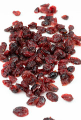 Dried red cranberries isolated on a white background.
