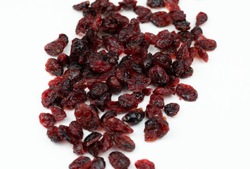 Dried red cranberries isolated on a white background.