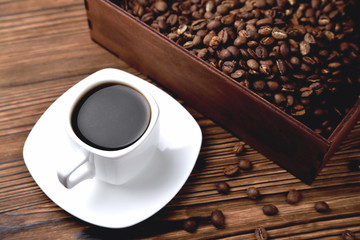 light coffee beans wooden box with coffee, natural wooden background