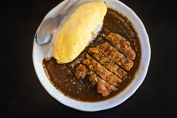 Japanese curry rice with fried chicken and omelet.