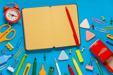 School office supplies on a desk with copy space. Back to school concept. School supplies on blue background. Back 2 school concept