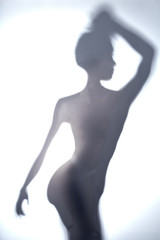 blurred image of young woman with raised arm looking aside. close up photo.
