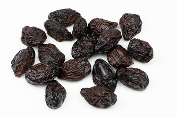 Dried plums isolated on a white background.