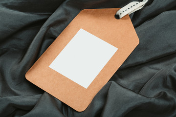 Rectangular Tag on a clothes. fashion, people and shopping concept - close up tag of clothing item