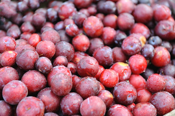 Plum fruit background, top view. Organic fresh fruit, plums close-up.
