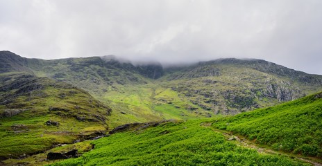 Fototapeta na wymiar The Wetherlam ridge hidden by mist