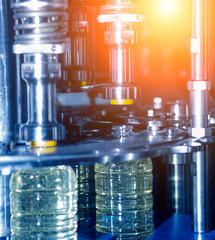 Bottling line of sunflower oil in bottles. Vegetable oil production plant. High technology.