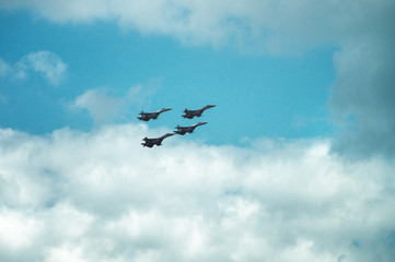 Group of four military aircraft of fighters, jet airplane in the sky make maneuvers