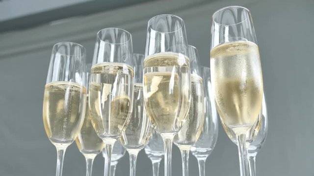 Glasses of champagne prosecco for restaurant guests at a wedding party or birthday party 4k slow motion.