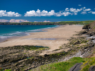 Newgale Beach in Pembrokeshire, Wales, UK on a summer day with blue sky and clouds