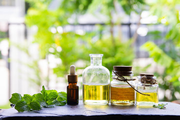 Peppermint essential oil is empty on the table and essential oil bottles - healthy ideas