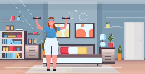 fat obese woman doing exercises with dumbbells overweight girl training workout weight loss concept modern house bedroom interior flat full length horizontal