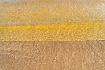 Transparent water of the lake on sandy shallow water.