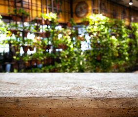 wooden table on blurred lightbulb cafe background