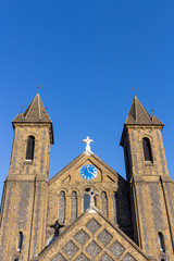 Fototapeta na wymiar Church towers clock with blue sky background