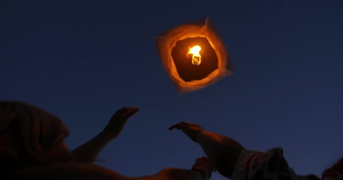 Group of friends spending time on the beach and making party. Having fun on a lonely tropical island