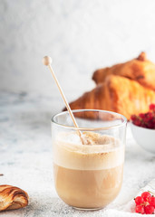 breakfast with cappuccino, croissants and berries, a glass of coffee, close-up